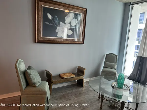 a living room with furniture and a painting on the wall