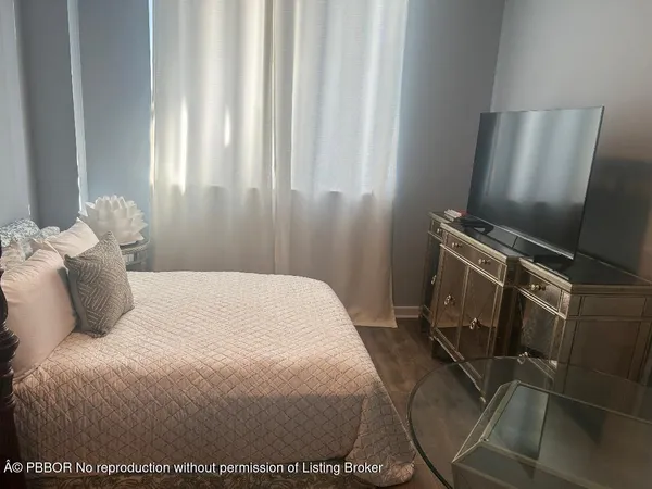 a bedroom with a bed and a mirror