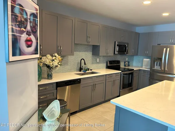 a kitchen with a sink a stove and cabinets