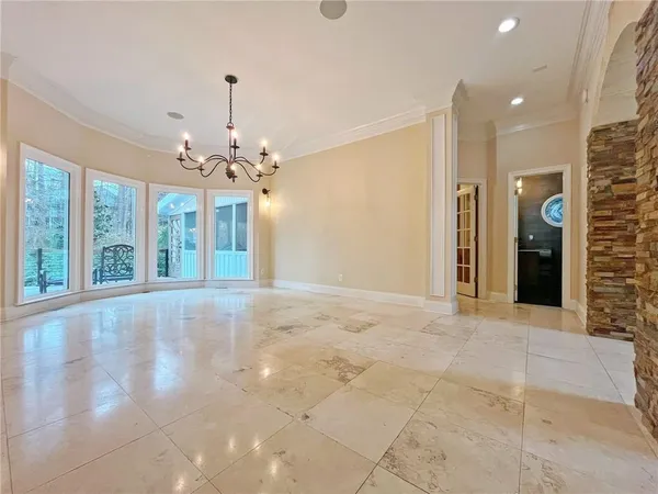a view of an empty room with a fireplace and a window