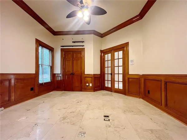 a view of an empty room with a fireplace and a window