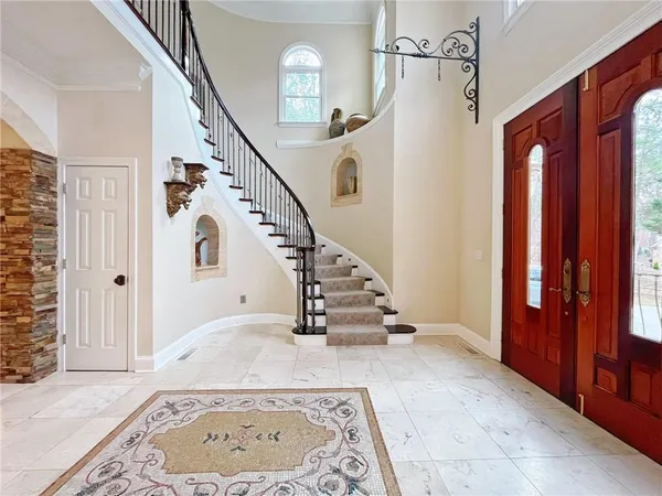 a large kitchen with kitchen island granite countertop a sink a counter top space and stainless steel appliances