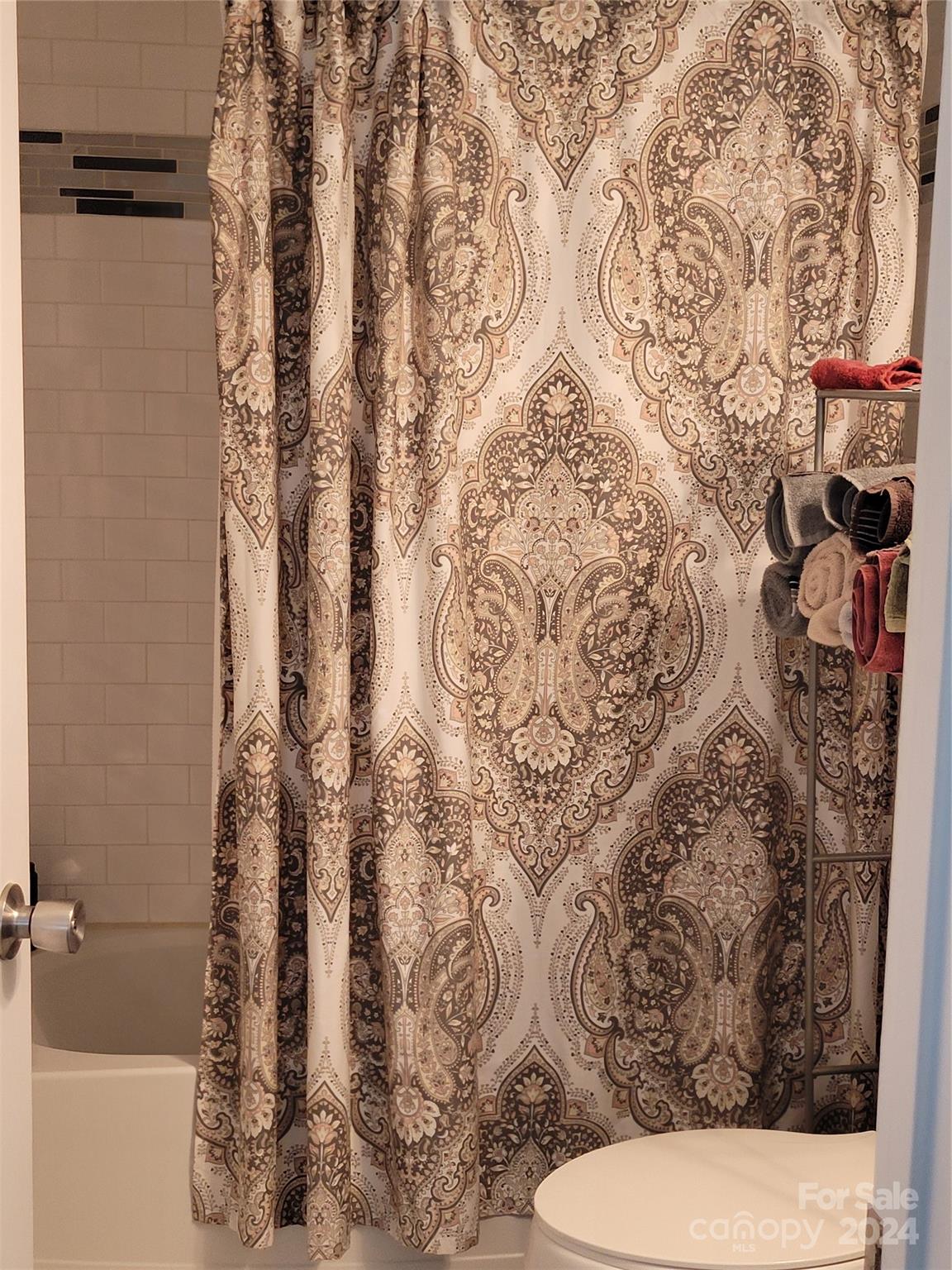 802 McLain Road Kannapolis, NC 28083 - Photo 16 of 20 a bathroom with a toilet and shower curtain
