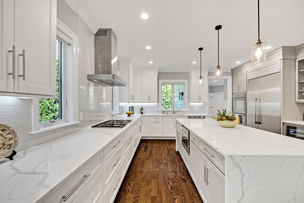 17 Sunrise Terrace Needham, MA 02492 - Photo 8 of 42 a large white kitchen with a large window and stainless steel appliances