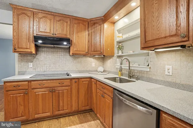 a kitchen with stainless steel appliances granite countertop a sink and cabinets