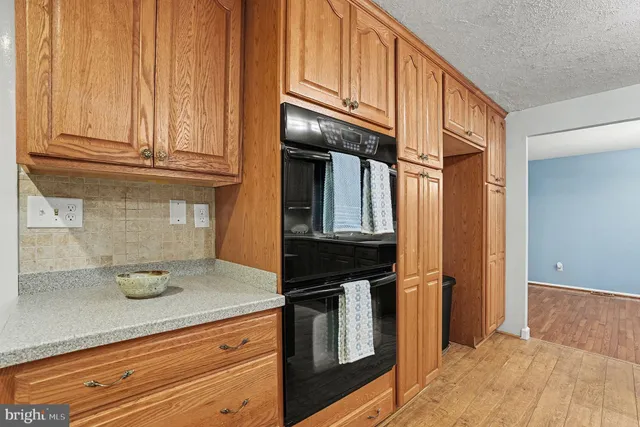 a kitchen with granite countertop cabinets stainless steel appliances and a counter space