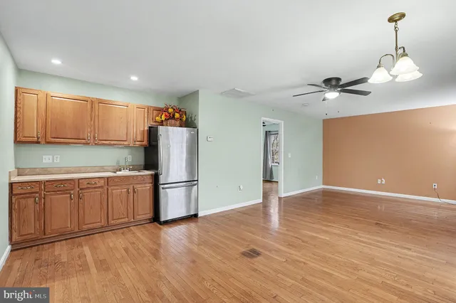 a kitchen with a refrigerator sink and cabinets