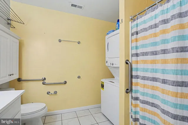 a bathroom with a toilet and a shower curtain