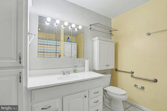 a bathroom with a sink a toilet a mirror and shower