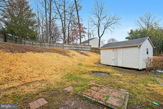a view of a yard with wooden fence