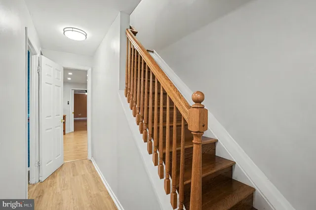 a view of entryway and gallery with wooden floor
