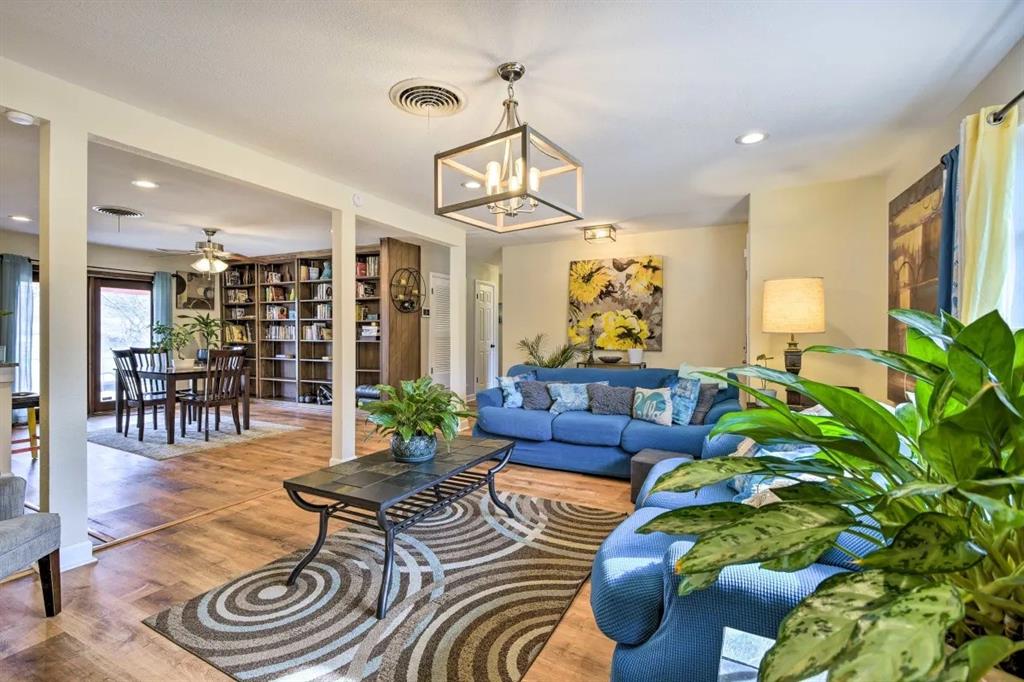 a living room with furniture and a chandelier