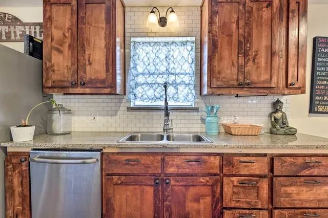 a kitchen with stainless steel appliances granite countertop a stove and a wooden floors