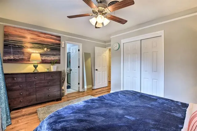a bedroom with a large bed and a chandelier