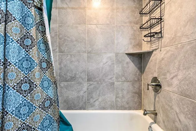 a bathroom with a granite countertop sink mirror vanity and toilet