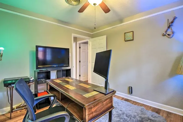a workspace with furniture and chandelier fan
