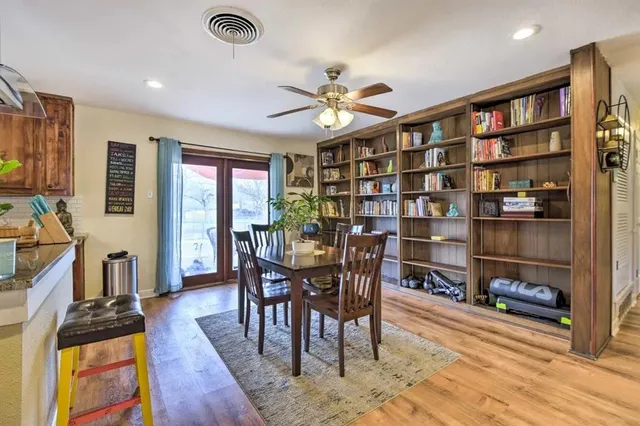 a view of a livingroom with furniture and a bookshelf