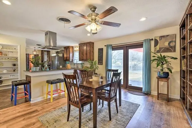 a view of a dining room with furniture and chandelier