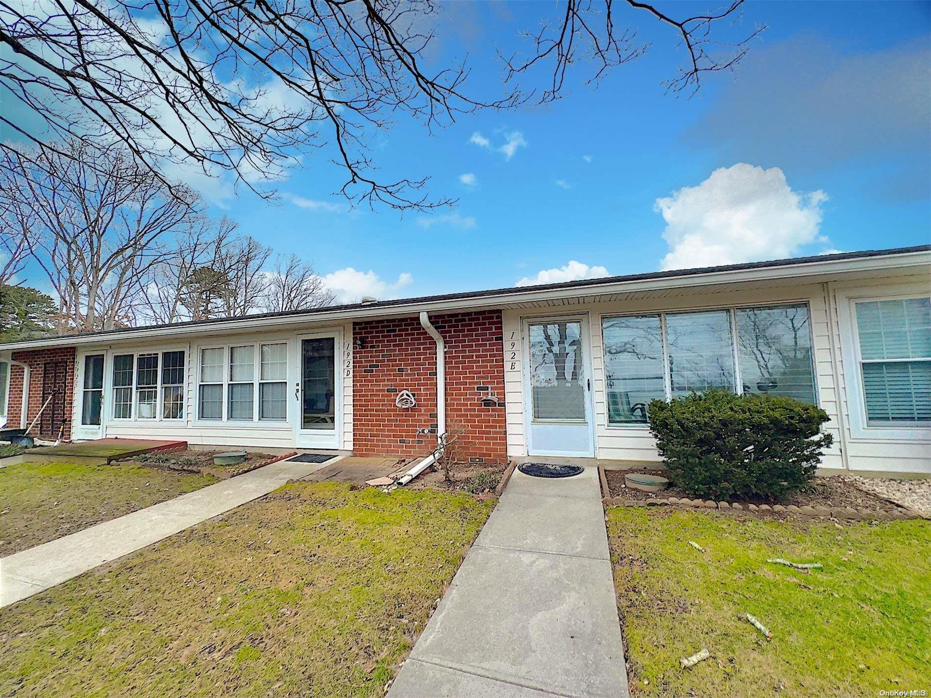 192 Ventry Court, Unit E Ridge, NY 11961 - Photo 1 of 1 a front view of house and yard with seating space