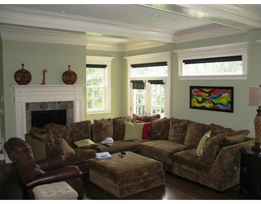 49 Woodland Road Brookline, MA 02467 - Photo 4 of 8 a living room with furniture a fireplace and a window