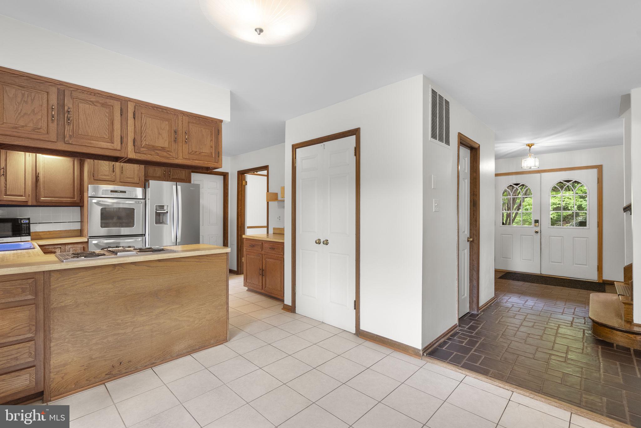 15220 Redgate Drive Silver Spring, MD 20905 - Photo 17 of 65 a kitchen with stainless steel appliances a refrigerator and a stove top oven