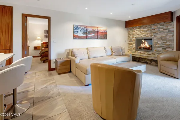 a bedroom with a bed and painting on the wall