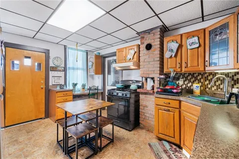 a kitchen with stainless steel appliances granite countertop a stove a sink dishwasher and a refrigerator