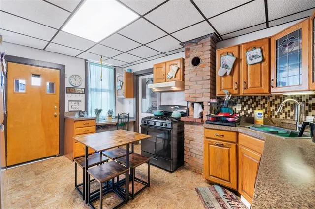 a kitchen with stainless steel appliances granite countertop a stove a sink dishwasher and a refrigerator