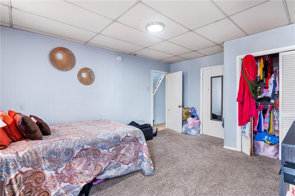 2312 Spring Street Pittsburgh, PA 15210 - Photo 16 of 29 a bedroom with a bed and a large mirror