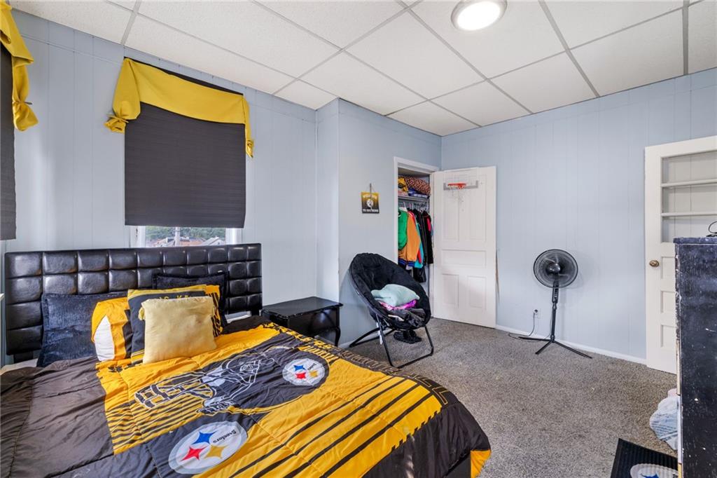 2312 Spring Street Pittsburgh, PA 15210 - Photo 19 of 29 a bedroom with furniture and a flat screen tv
