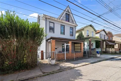a front view of a residential apartment building with a yard