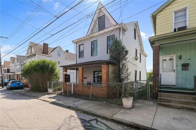 a front view of a house with parking area