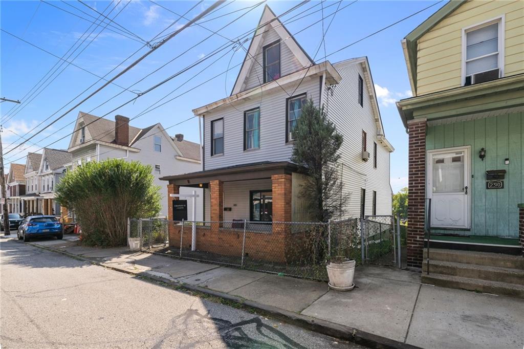2312 Spring Street Pittsburgh, PA 15210 - Photo 3 of 29 a front view of a house with parking area