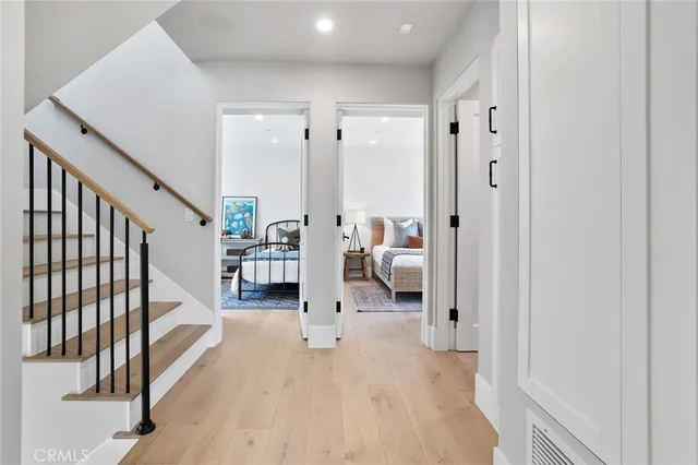 a hall way with furniture a wooden floor and windows