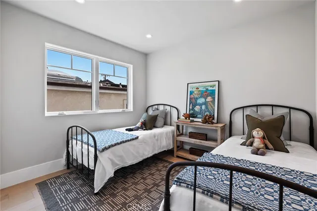 a bedroom with two beds and a window