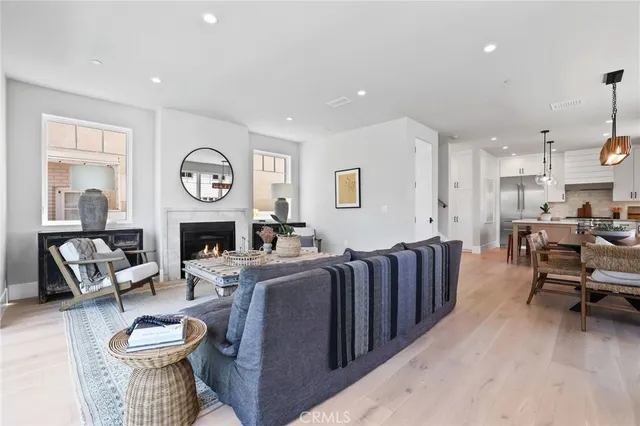 a living room with furniture a fireplace and a window