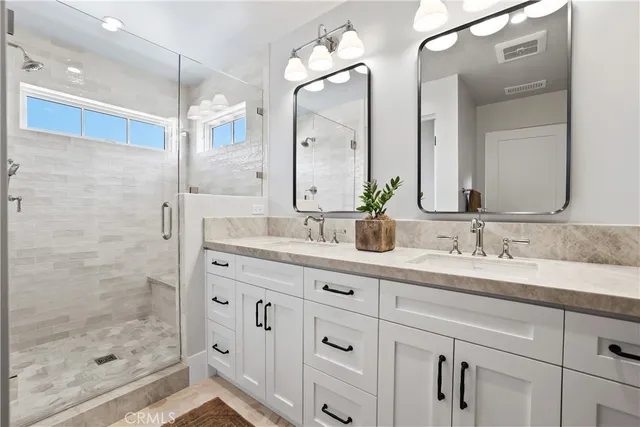a bathroom with a granite countertop sink mirror and double
