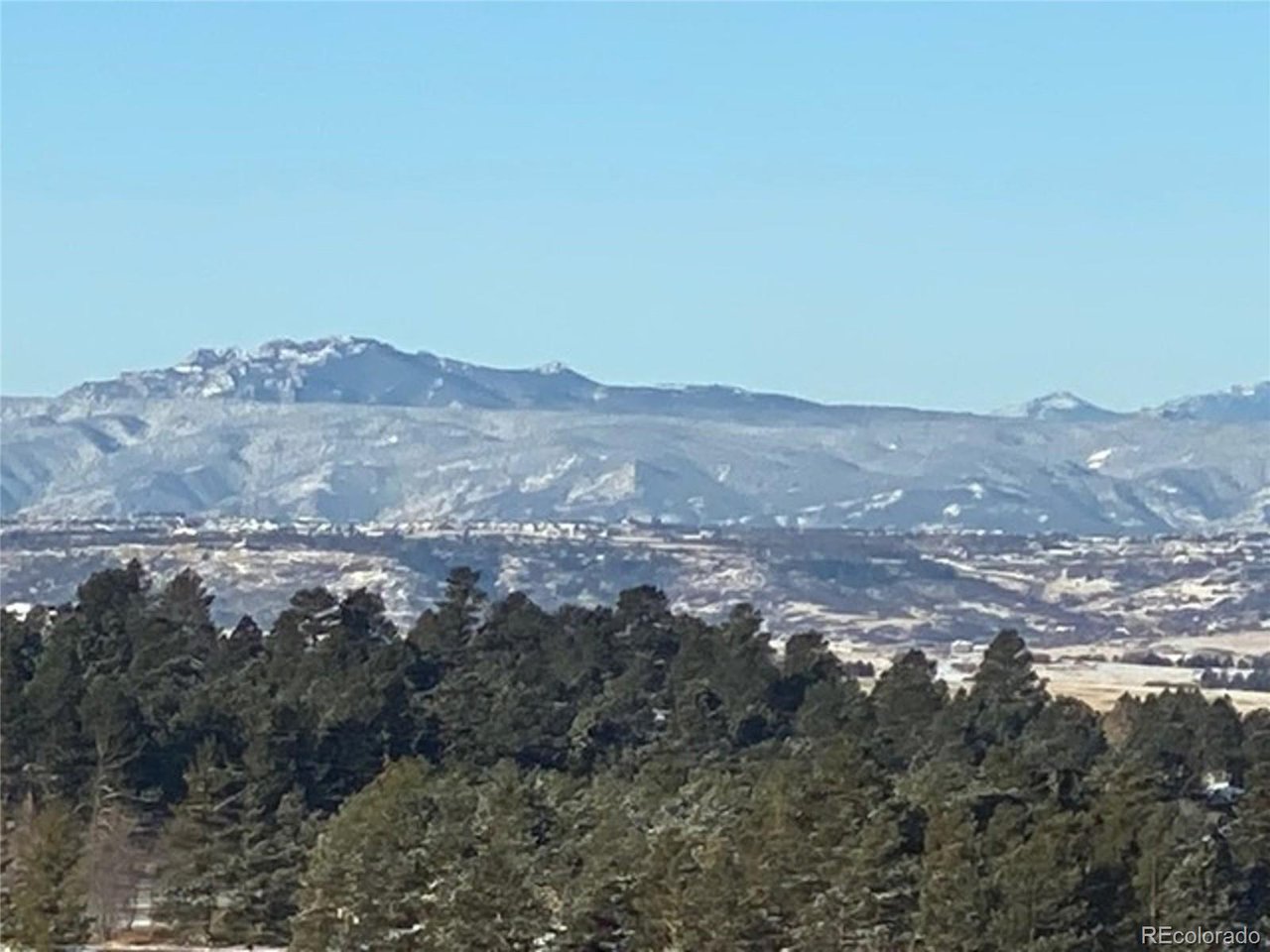 Woodhaven Ridge Road Parker, CO 80134 - Photo 30 of 36 a view of a big yard with mountains in the background