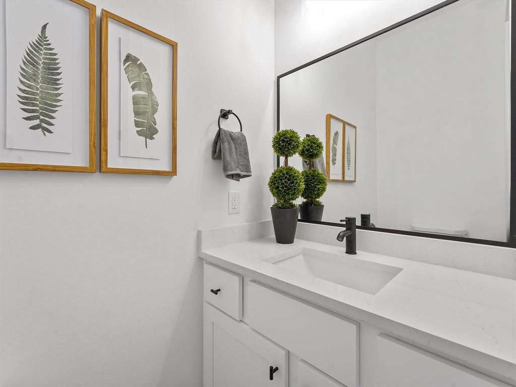 2406 Mann Street, Unit D Houston, TX 77093 - Photo 13 of 15 a bathroom with a sink and a mirror