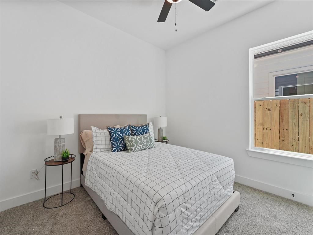 2406 Mann Street, Unit D Houston, TX 77093 - Photo 6 of 15 a bedroom with a bed and a window
