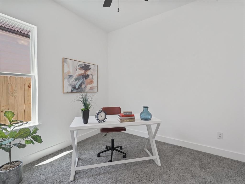 2406 Mann Street, Unit D Houston, TX 77093 - Photo 8 of 15 a workspace with furniture and a potted plant