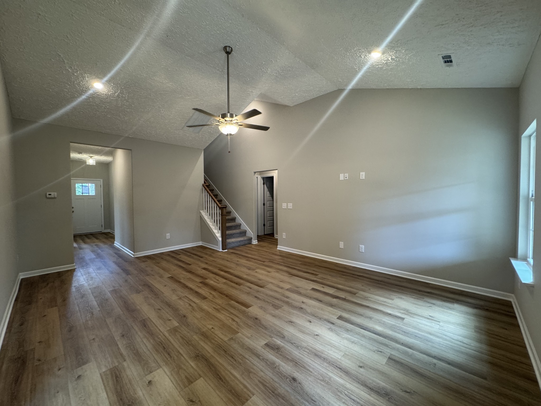 69 Laurel View Street Manchester, TN 37355 - Photo 6 of 15 an empty room with wooden floor chandelier and entryway