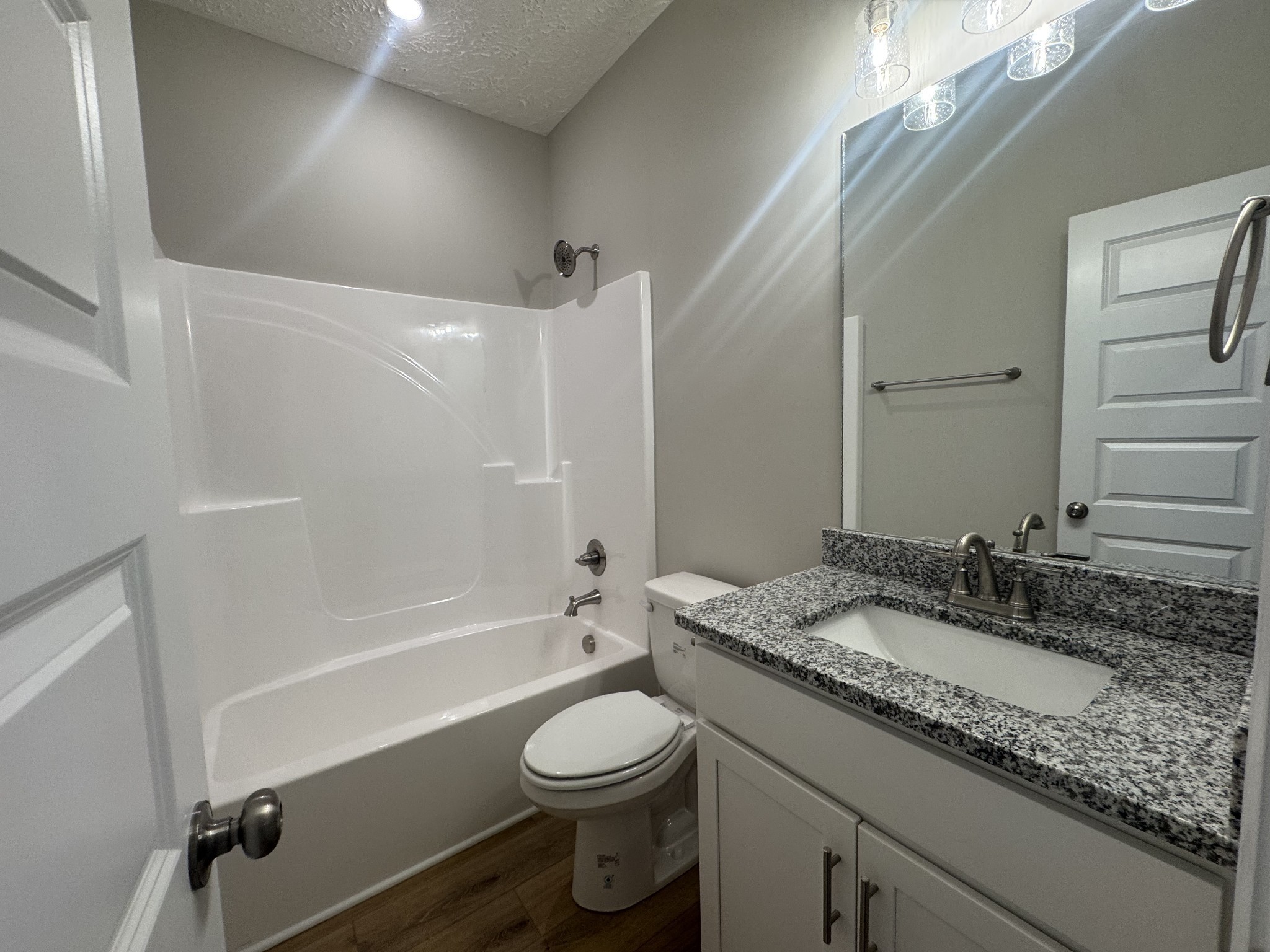 69 Laurel View Street Manchester, TN 37355 - Photo 9 of 15 a bathroom with a granite countertop sink toilet a mirror and shower