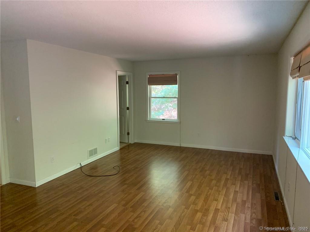 380 Huckleberry Hill Road Avon, CT 06001 - Photo 13 of 21 an empty room with wooden floor and windows