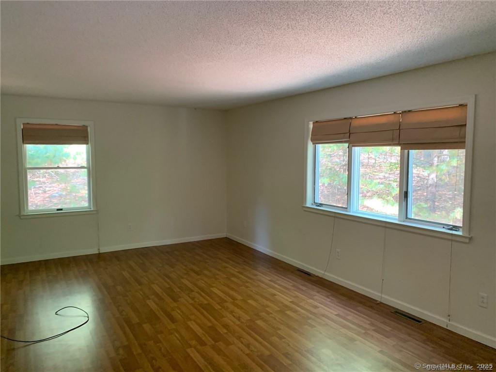 380 Huckleberry Hill Road Avon, CT 06001 - Photo 14 of 21 an empty room with wooden floor and windows