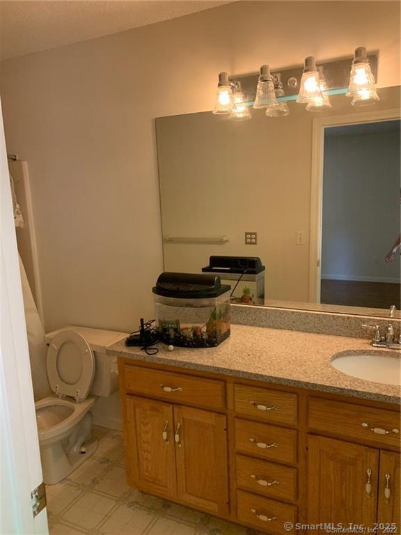 380 Huckleberry Hill Road Avon, CT 06001 - Photo 20 of 21 a bathroom with a granite countertop sink and a mirror