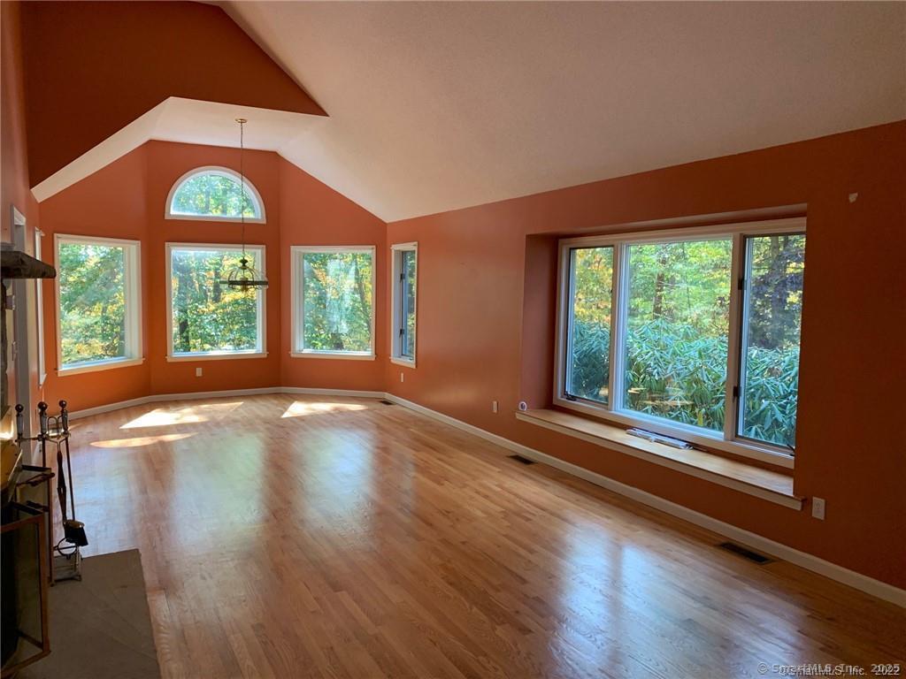 380 Huckleberry Hill Road Avon, CT 06001 - Photo 2 of 21 a view of an empty room with wooden floor windows and a fireplace