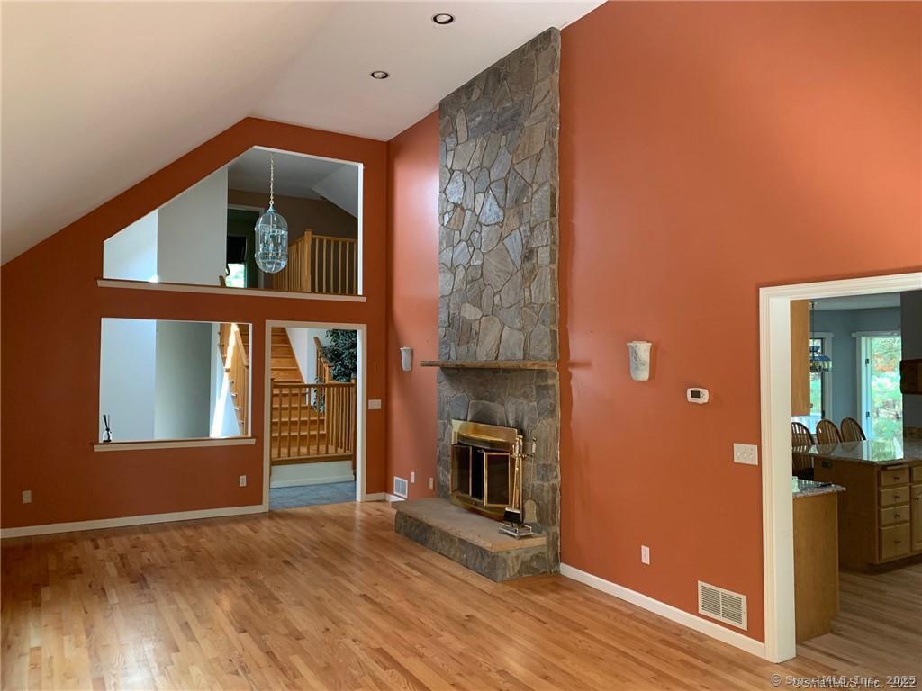 380 Huckleberry Hill Road Avon, CT 06001 - Photo 5 of 21 a view of a livingroom with wooden floor and a fireplace