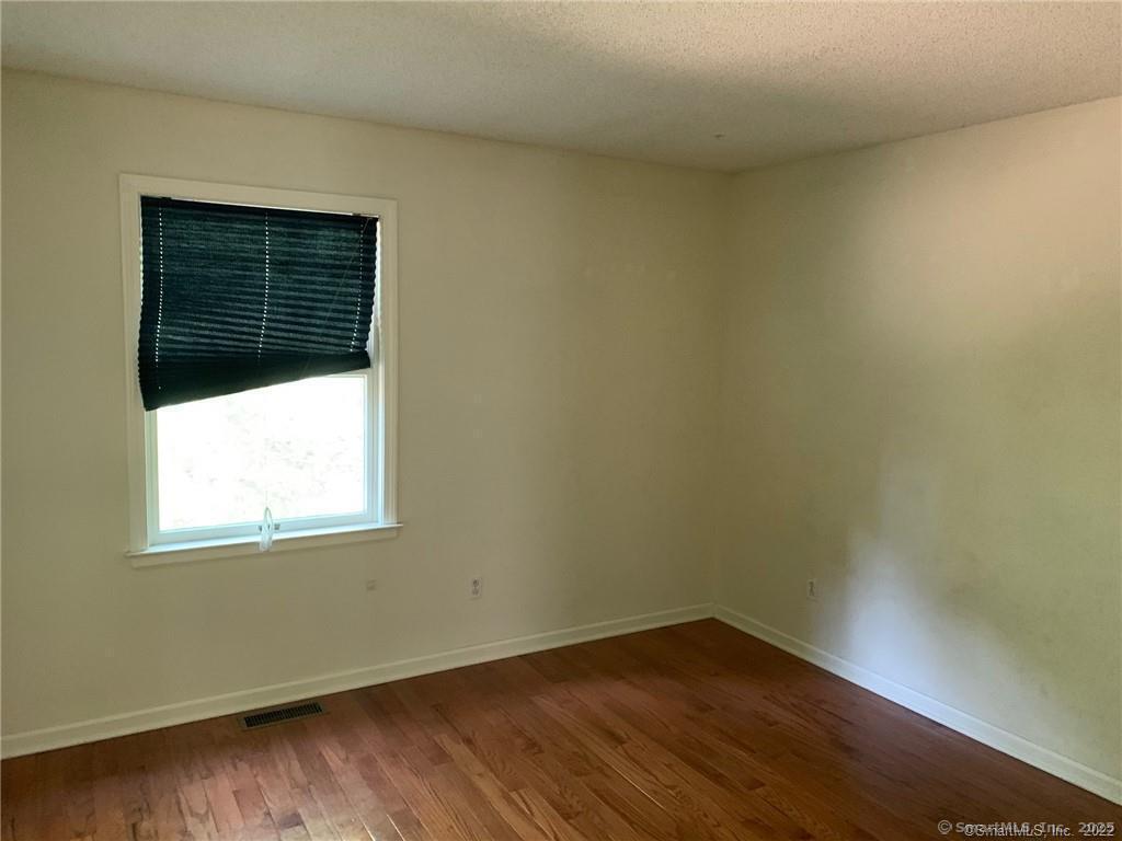 380 Huckleberry Hill Road Avon, CT 06001 - Photo 10 of 21 a view of an empty room with wooden floor and a window