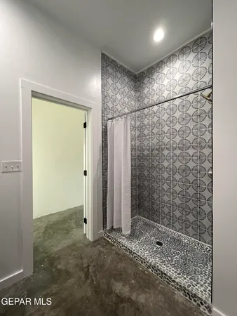 a bathroom with a shower and a sink